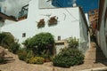 House facade with white walls, stairs, flower pots and plants at Caceres