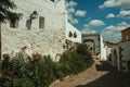 House facade with white walls, stairs, flower pots and plants at Caceres