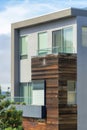 House facade with wooden frame and moddern beige stucco house frame with windows and flat roof Royalty Free Stock Photo