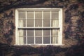 House facade with wooden white window covered with wild berries and red vines Royalty Free Stock Photo