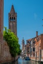 House facades and church bell towers along a canal in Venice, Italy