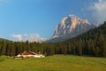 House farm with green forest and Tofane peak, Dolomites Alps Royalty Free Stock Photo