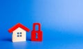 House figurine and a red padlock. Security and safety. Confiscation for debts. alarm system. seizure of property. Protection