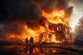 A house on fire with firemen in front of it. A burning house in flames during the day