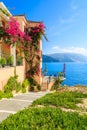 House with flowers along walkway to beach on coast of Kefalonia island in Assos village, Greece Royalty Free Stock Photo