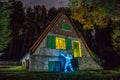 House in the forest illuminated with lanterns