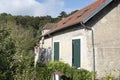 House in France with plastered walls and windows with colored shutters Royalty Free Stock Photo