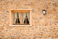 house front with yellow irregular natural stone blocks and wooden lattice window Royalty Free Stock Photo