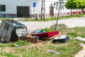 House furniture dumped in the garbage on the street in the city near metal dumpster junk can