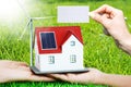 The house of the future with renewable energy sources and empty piece of paper as background, add copy or text