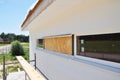 House garage wall renovation with plastering, painting walls, soffit installation. Garage windows