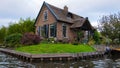 A house in Giethoorn, the Netherlands, photographed on water channels on a fall day, with green grass, and special architecture of Royalty Free Stock Photo