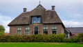 A house in Giethoorn, the Netherlands, photographed on water channels on a fall day, with green grass, and special architecture of Royalty Free Stock Photo