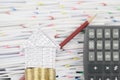 House on gold coins have blur brown pencil lean calculator Royalty Free Stock Photo