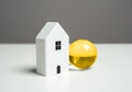 House and golden globe of the Earth. Foreign real estate. Royalty Free Stock Photo