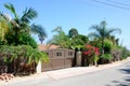 House with green lawn manicured frontyard garden in suburban residential neighborhood Royalty Free Stock Photo