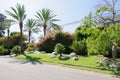 House with green lawn manicured frontyard garden in suburban residential neighborhood Royalty Free Stock Photo