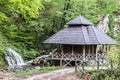 House for grinding wheat by water in the forest