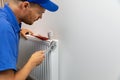 House heating system installation plumber installing radiator