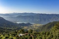 House on a hill, against the background of the city of Pokhara in a mountain foggy morning valley with Phewa lake under a clear