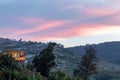 House on a hill and Cabbage grown on the farm land. Royalty Free Stock Photo