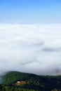 House on a hill with sea of clouds Royalty Free Stock Photo