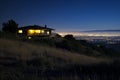 house on a hilltop, city lights in the distant night Royalty Free Stock Photo