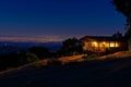 house on a hilltop, city lights in the distant night Royalty Free Stock Photo