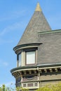 House or home with spire or turrent structure with windows and gable roofs with green wooden tiles of timber midday sun Royalty Free Stock Photo