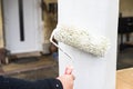 House improvement, painter is painting column white with painter roller Royalty Free Stock Photo