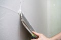 House improvements. putting plaster on the wall with spatula Royalty Free Stock Photo