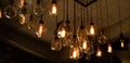 House interior of loft and rustic style. Beautiful vintage luxury light bulb hanging decor glowing in dark. Royalty Free Stock Photo