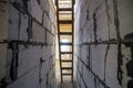 House interior under construction and renovation. Perspective view of wooden ladder, future staircase in long corridor passage Royalty Free Stock Photo