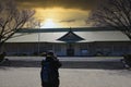 house in japanese park with a photographer in front at sunset