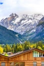 House in Kandersteg, snow mountains, Switzerland