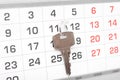 A house key on a calendar background