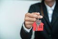 House key in hand, Female hand holding house key, real estate agent Royalty Free Stock Photo