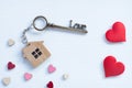 House key in heart shape with home keyring on old wood background decorated with mini heart Royalty Free Stock Photo