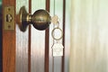 House key with home keyring in keyhole, property concept Royalty Free Stock Photo