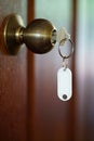 House key with home keyring in keyhole, property concept, empty tag Royalty Free Stock Photo