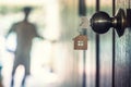 House key with home keyring in keyhole on wood door Royalty Free Stock Photo