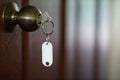 House key with home keyring in keyhole, property concept, empty tag Royalty Free Stock Photo