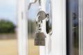 House key on a house shaped silver keyring in the lock of a door Royalty Free Stock Photo