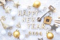 House key with keychain cottage on cozy festive knitted background with stars, bokeh. Happy New Year 2024 wooden letters, greeting