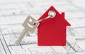 House key on keyring over construction plan