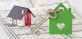 House key with model house over construction plan Royalty Free Stock Photo