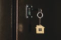 House key with house model keychain in door. process of opening the front door to the apartment Royalty Free Stock Photo