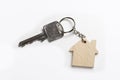 House key on house shaped keyring on white background Royalty Free Stock Photo