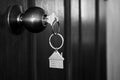 House key in wooden front door in black and white color tone Royalty Free Stock Photo