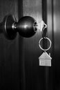 House key in wooden front door in black and white color tone Royalty Free Stock Photo